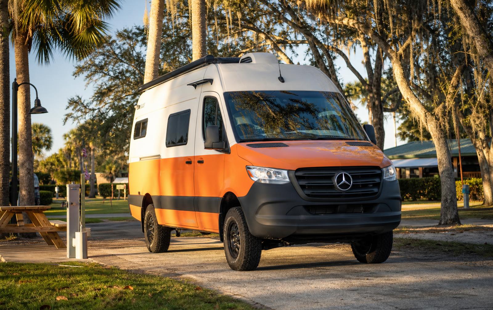Compact Class B camper van parked at a Florida RV park